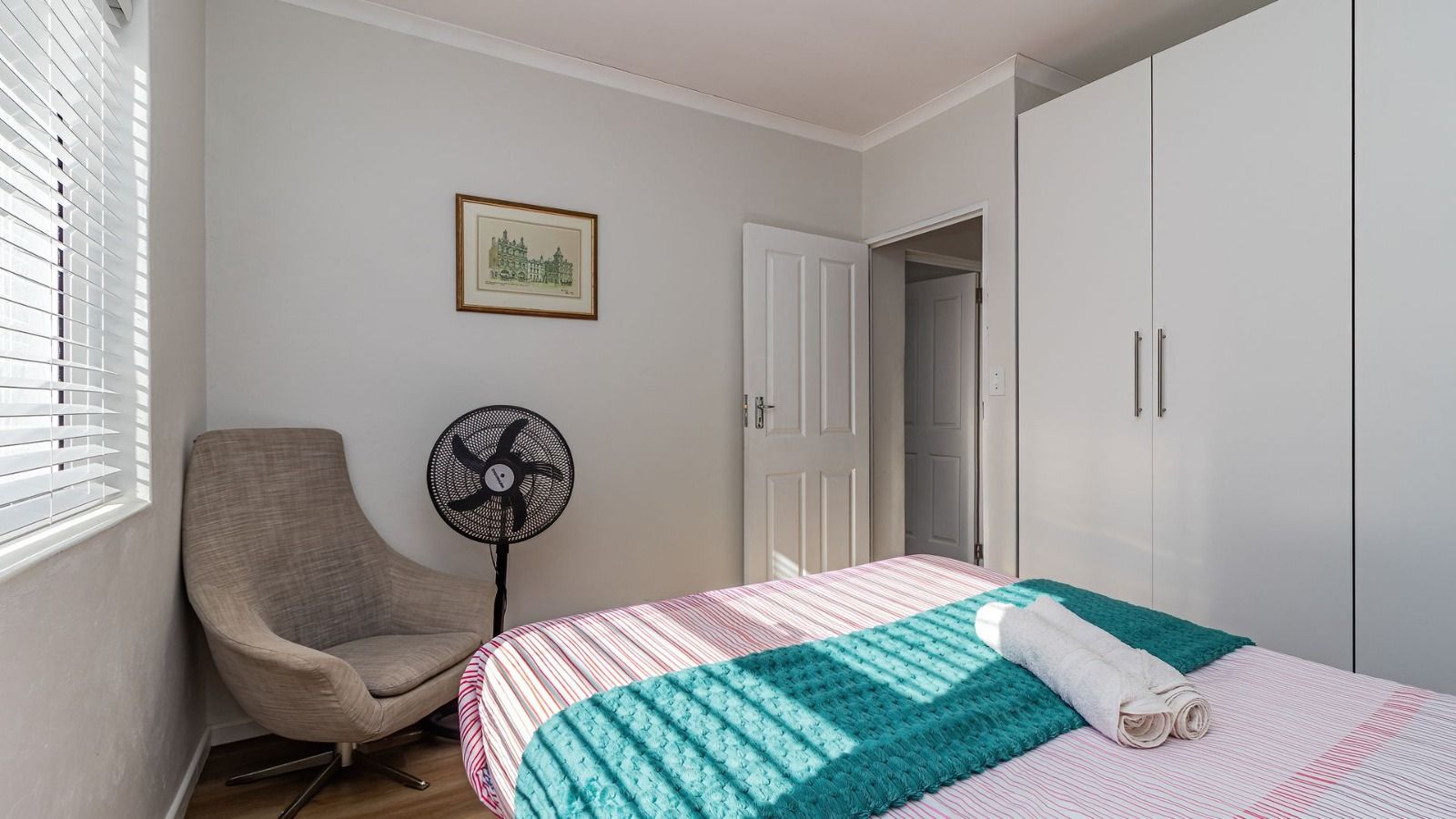 Bedroom with armchair and wardrobe