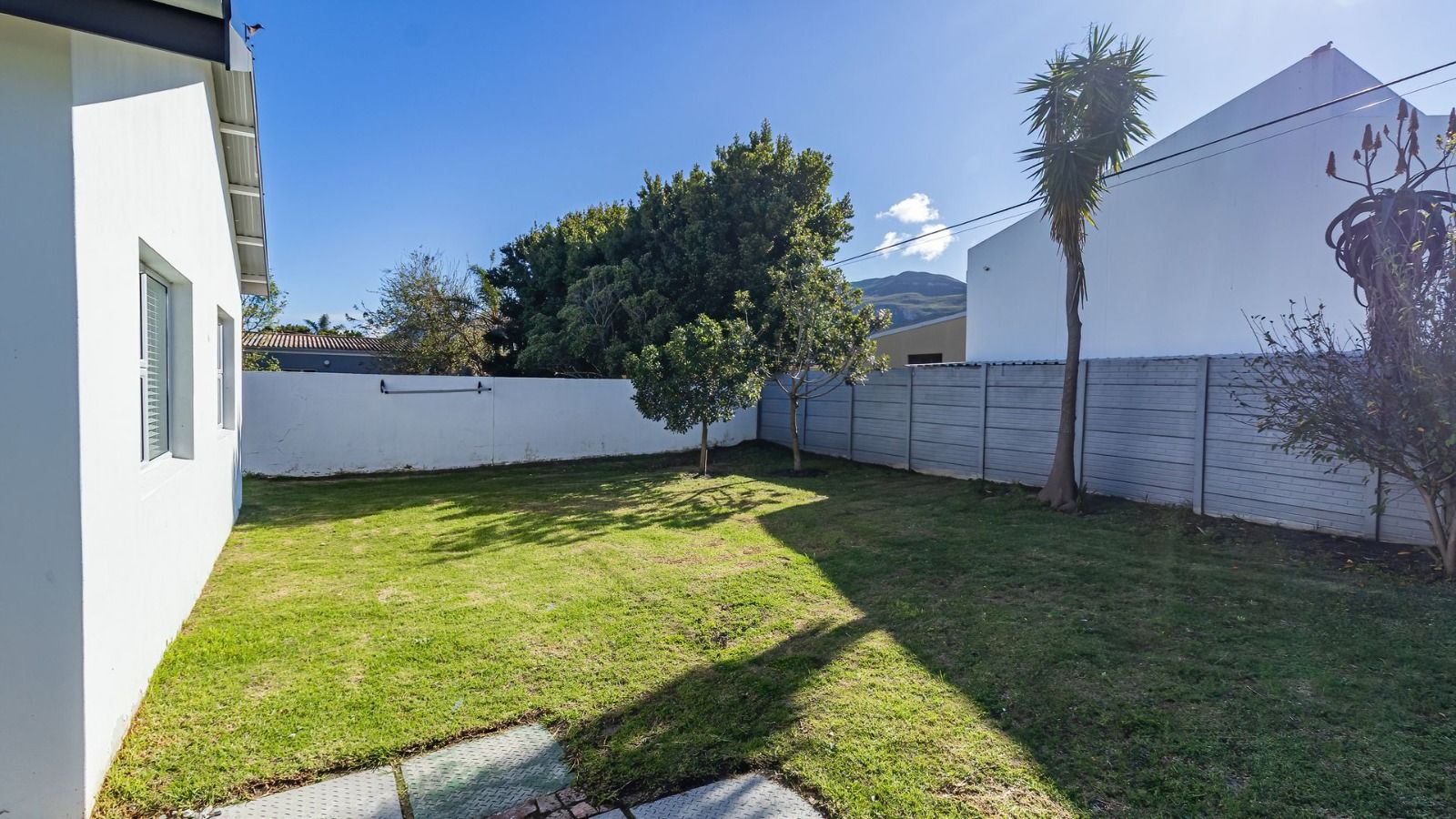 Enclosed garden with lawn and trees